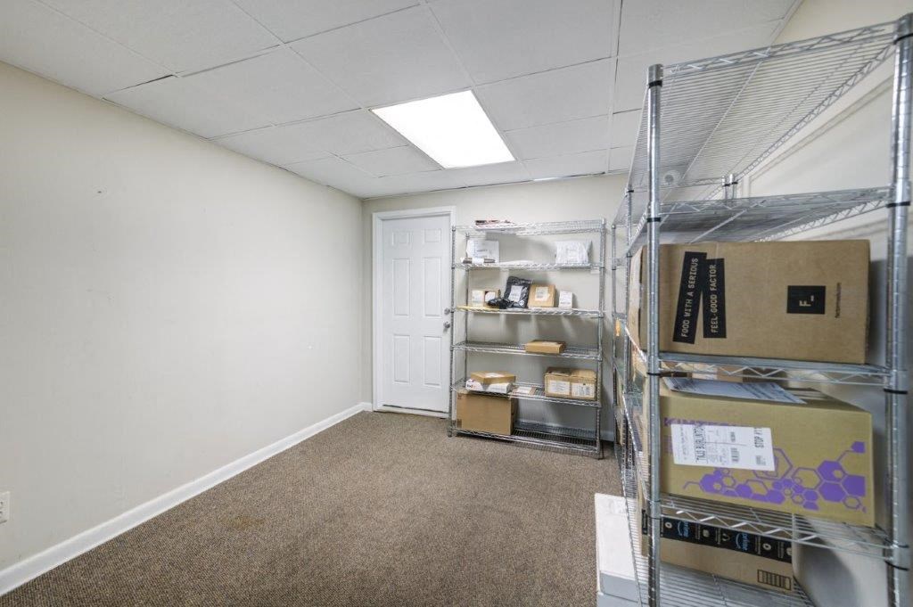a room with shelves and boxes in it and a door