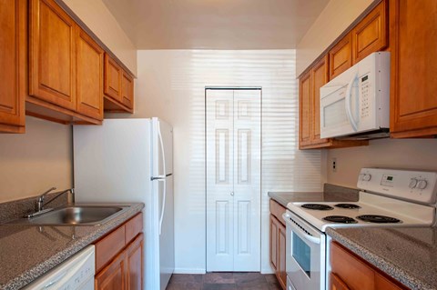 a kitchen with a stove refrigerator and sink