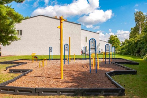 a playground with a building in the background