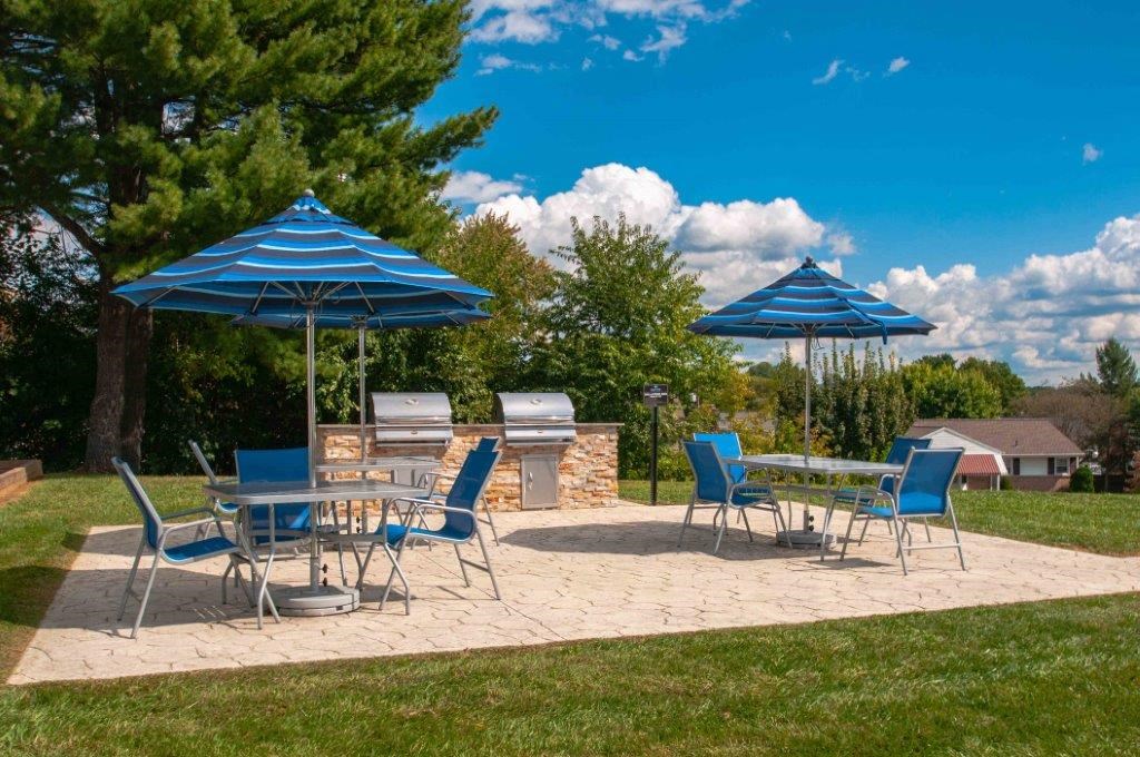 a patio with tables and chairs and umbrellas