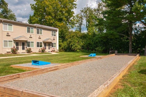 a backyard with a gravel area and a house