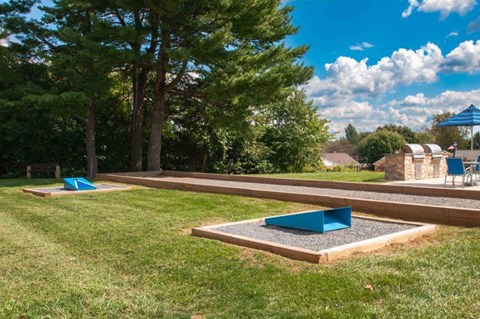 a park with a pool and grass and trees