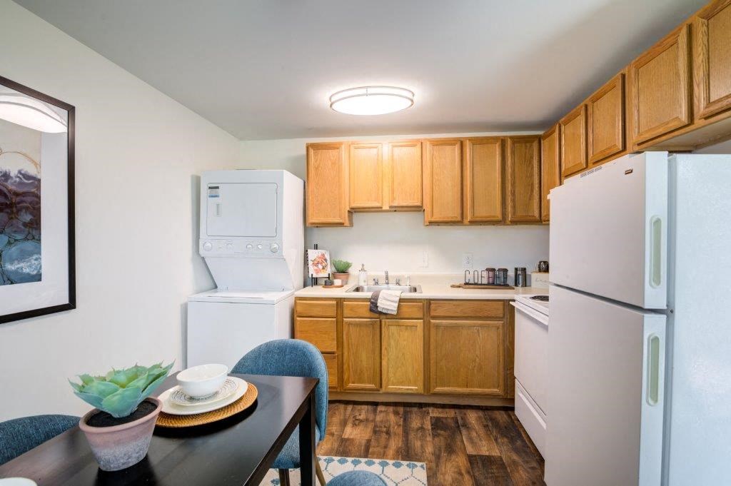 a kitchen with white appliances and wooden cabinets