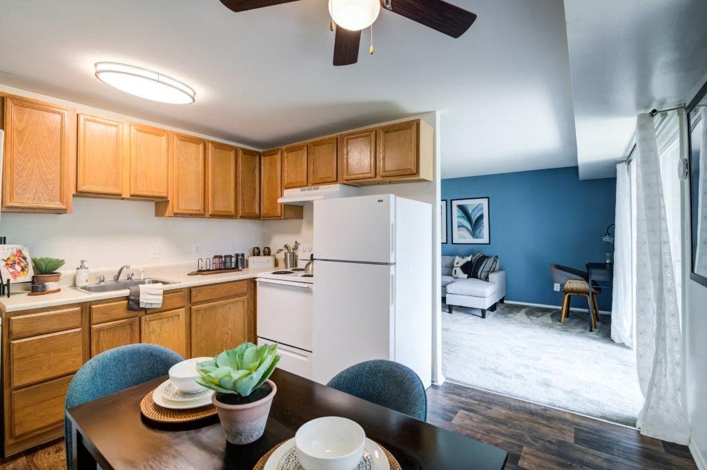 a kitchen with a dining table and a refrigerator