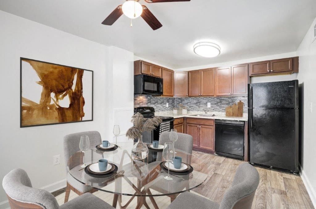 a kitchen and dining room with a glass table and chairs