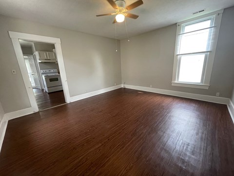 A room with a ceiling fan and a window.