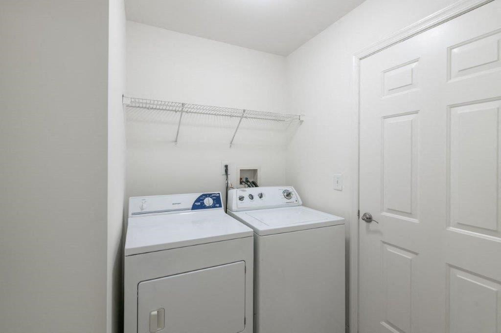 a washer and dryer in a white room with a white door