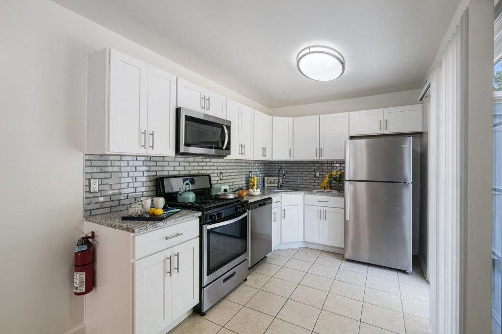 a kitchen with stainless steel appliances and white cabinets