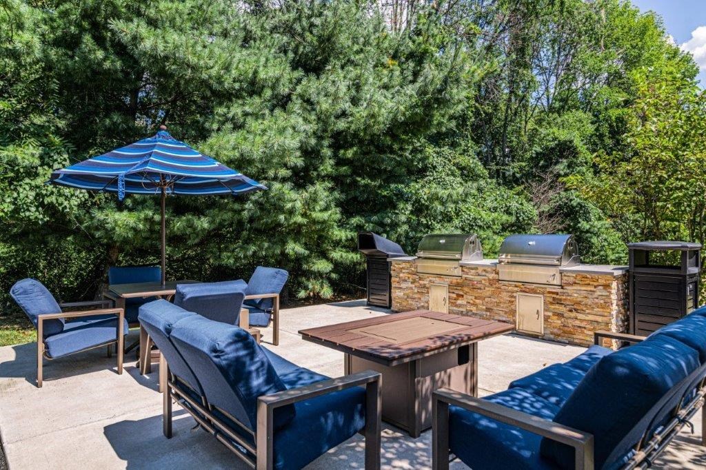 a patio with a table and chairs and an umbrella