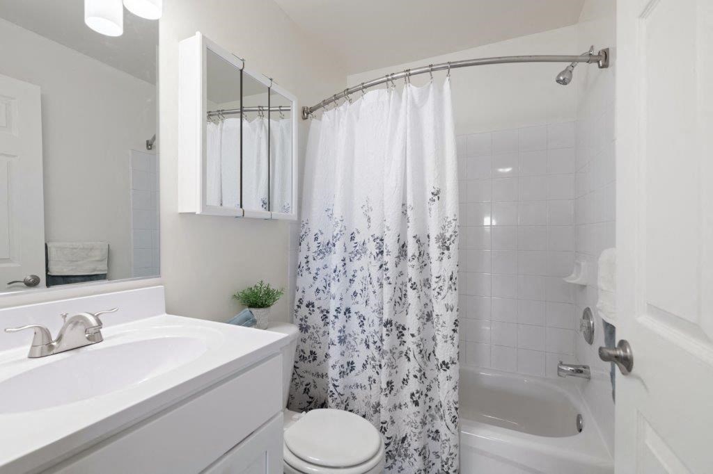 a bathroom with a shower and a sink and a toilet