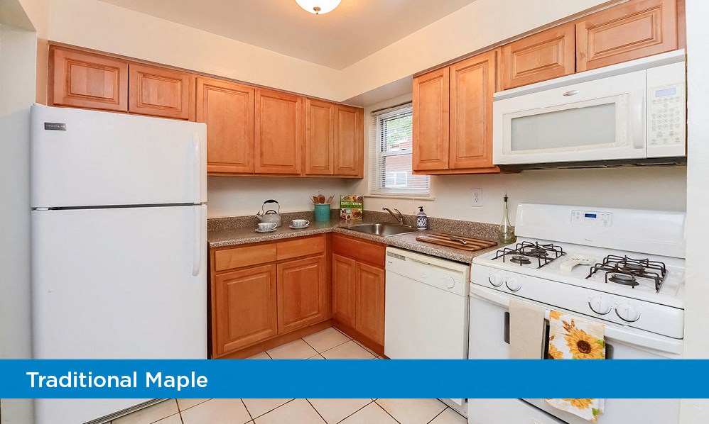 a kitchen with white appliances and wooden cabinets