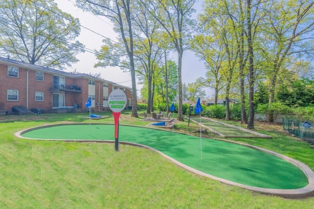 a mini golf course is next to a brick building