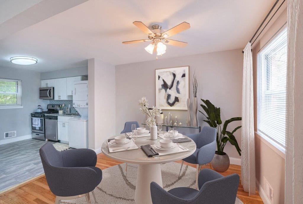 a dining room with a table and chairs and a ceiling fan
