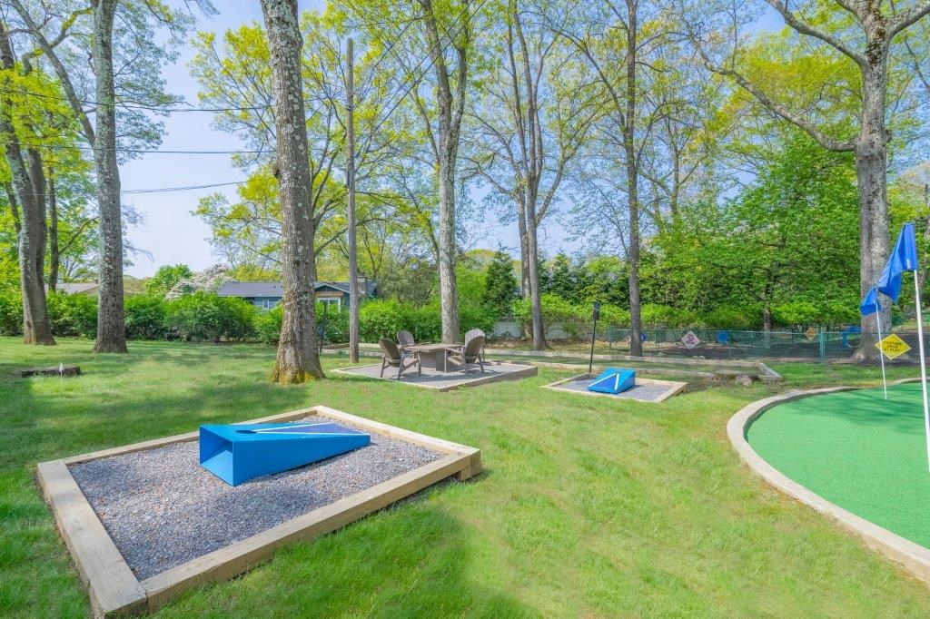 a park with several trampolines in the grass