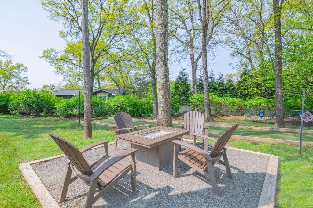 a patio with a table and chairs in a park