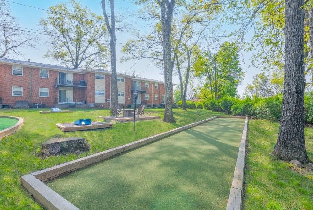 a walking path in front of a brick apartment building