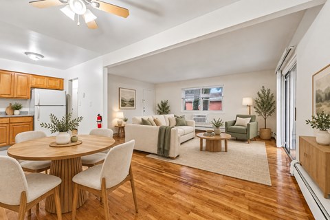 A well-lit, spacious living room with a dining table and chairs.