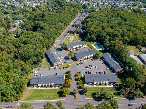 an aerial view of a parking lot and rooftops of buildings