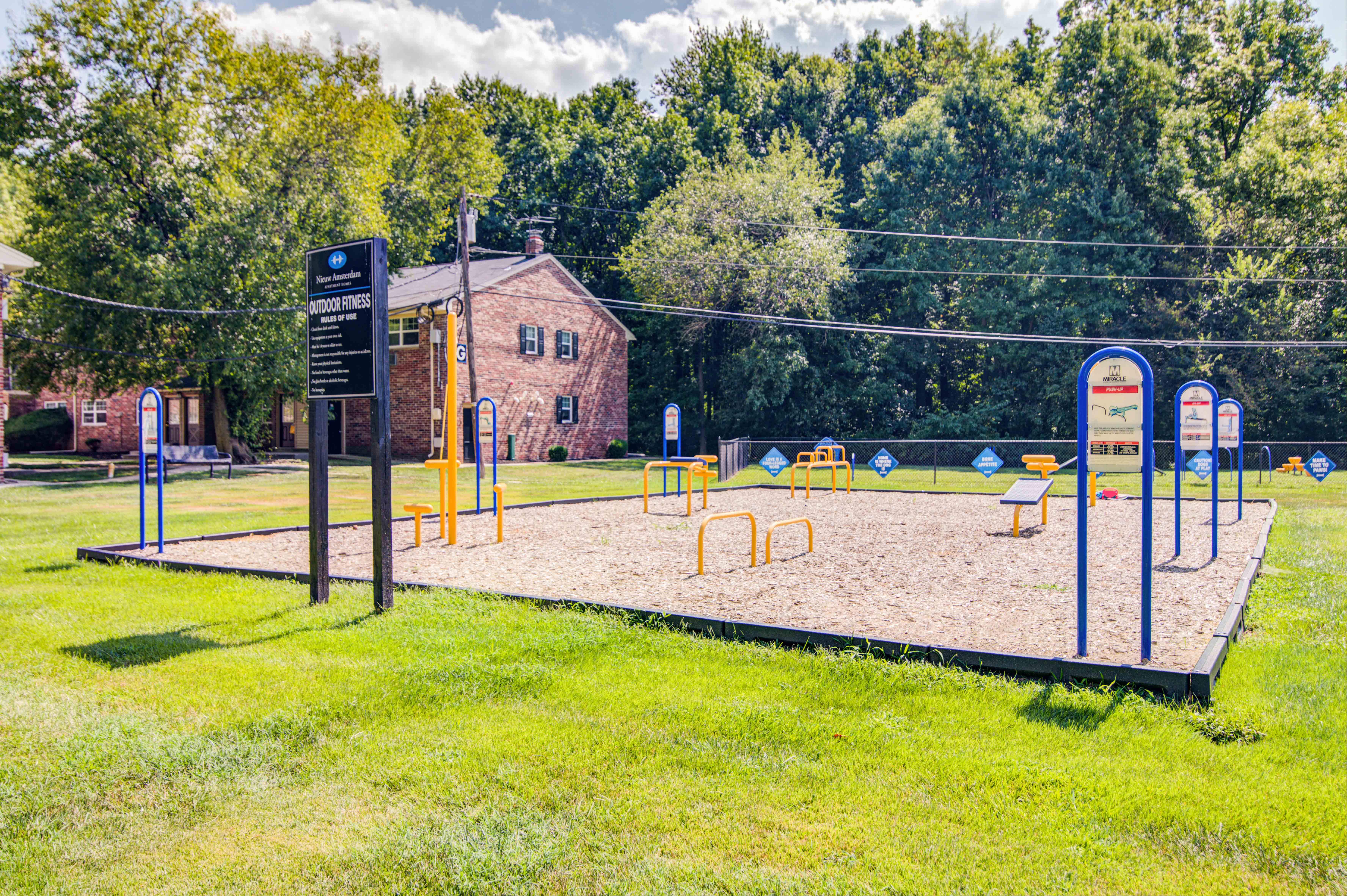 a playground in a park with a house in the background