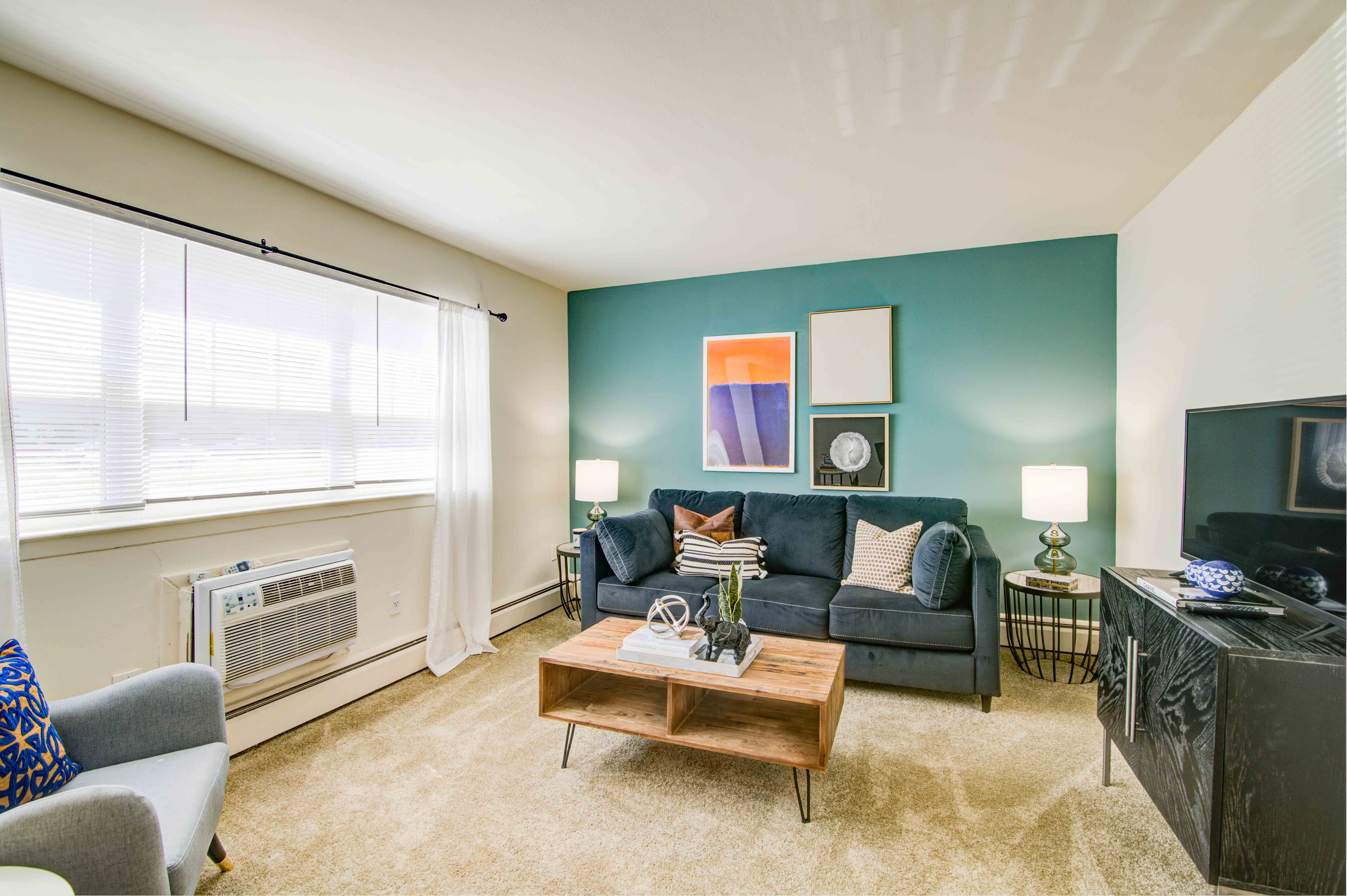 a living room with a blue wall and a couch and a table