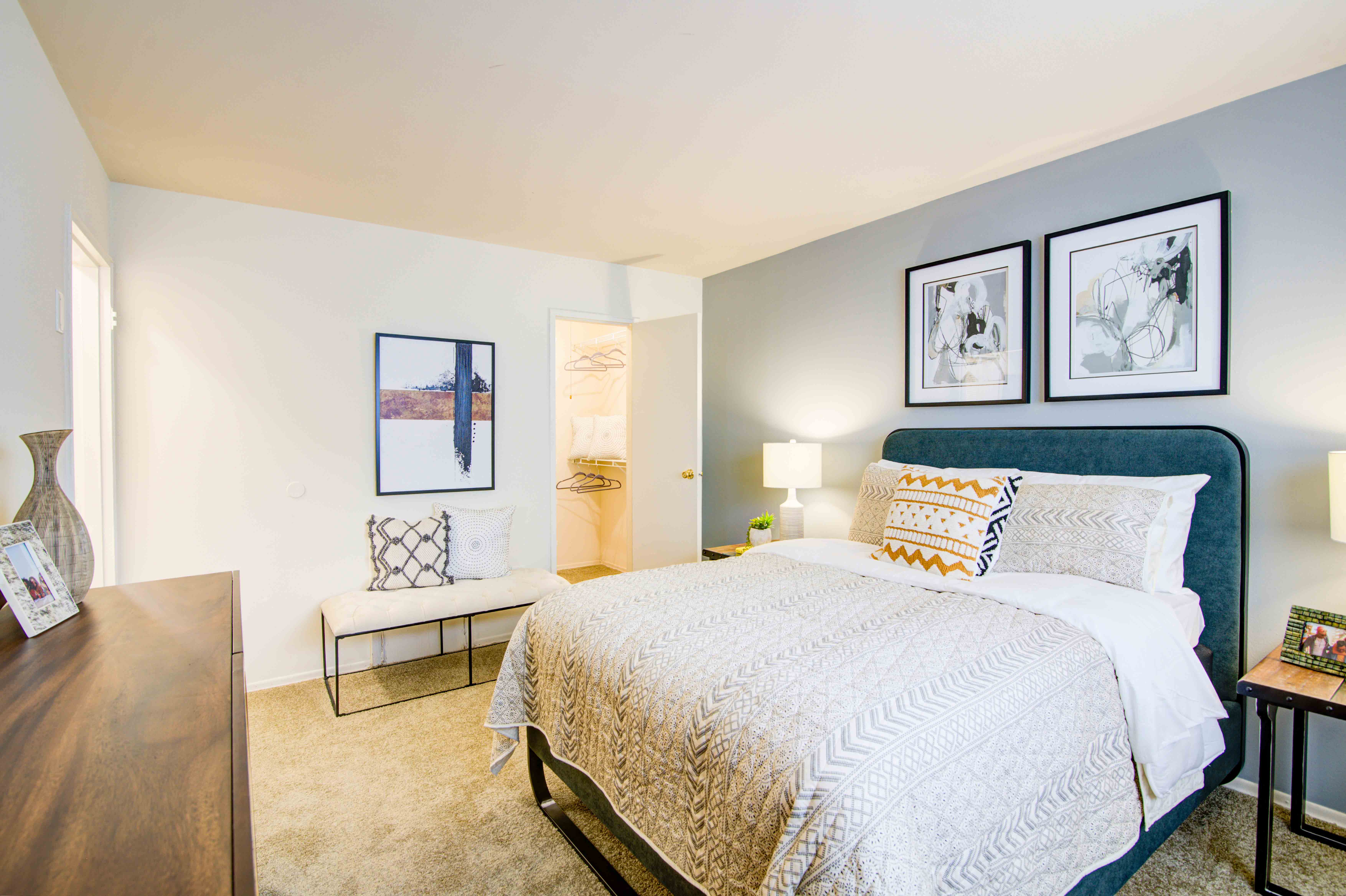 a bedroom with a bed and a chair and a window