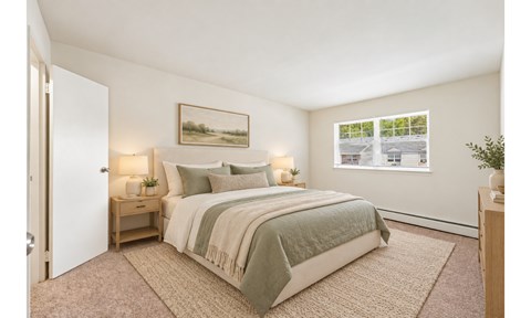 A bedroom with a bed, nightstand, and a painting on the wall.