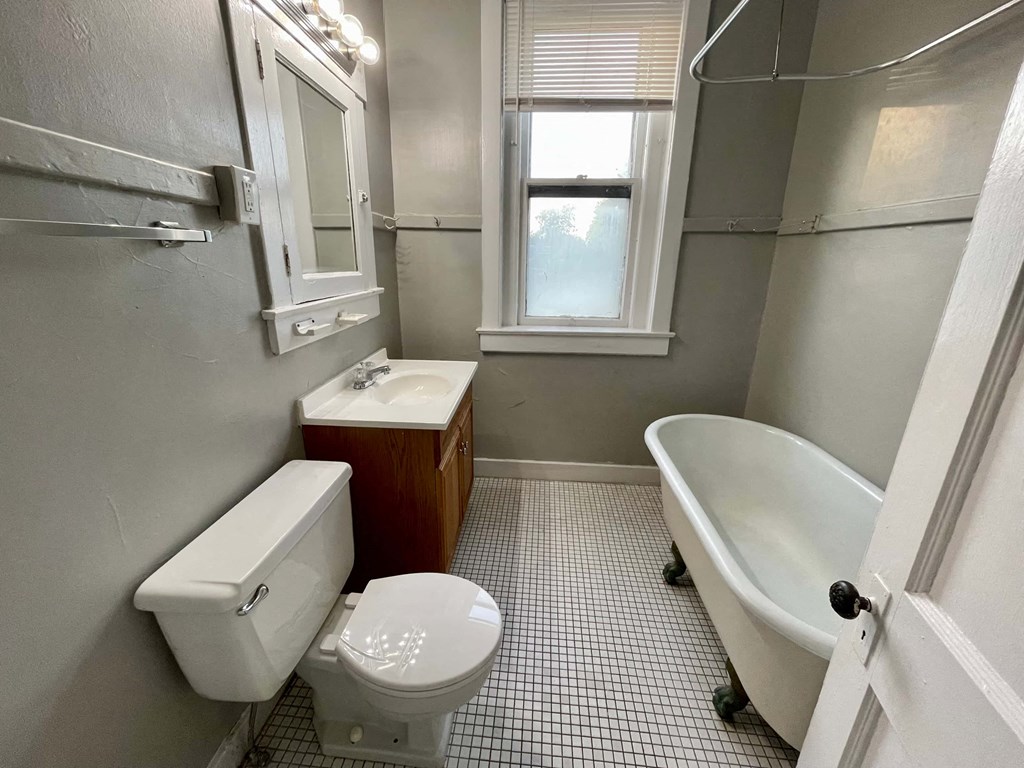 a bathroom with a toilet sink and a bath tub