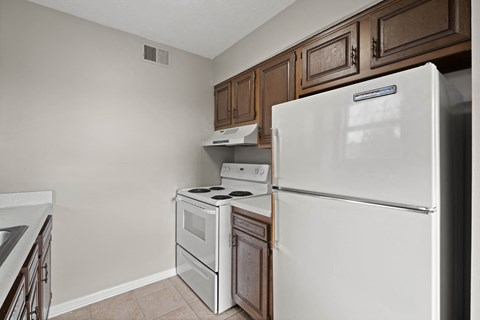 a kitchen with a refrigerator and a stove and a microwave