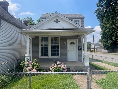 a house with a white door and a chain link fence