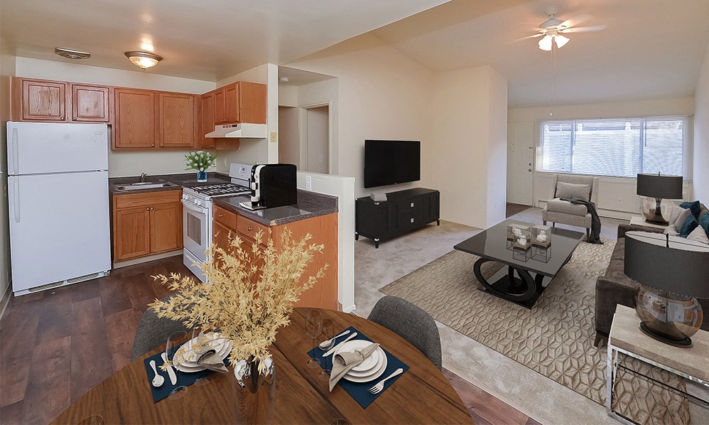 an open kitchen and living room with a dining room table