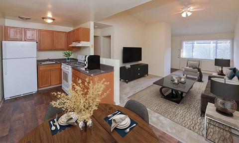 an open kitchen and living room with a dining room table