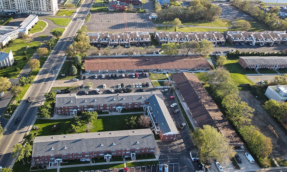 an aerial view of a parking lot and several buildings
