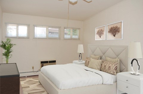 a bedroom with a bed and a dresser and a window