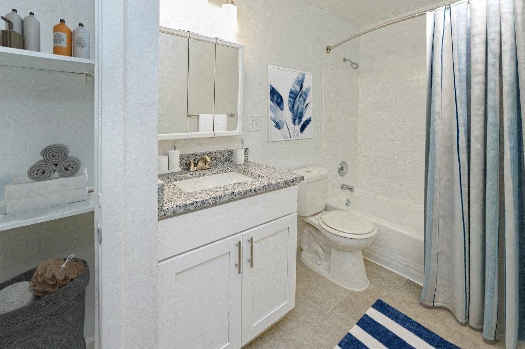 a bathroom with a sink toilet and a shower