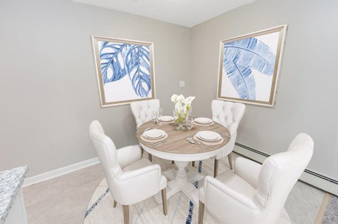 a dining room with a table and chairs