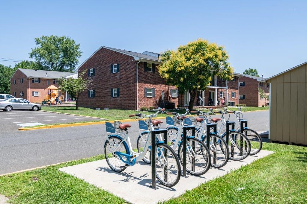 a row of bikes parked in front of a building