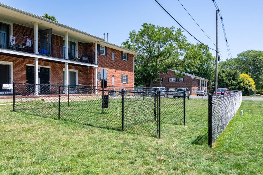 a chain link fence in front of an apartment building