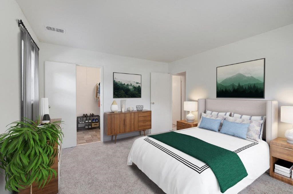 a bedroom with a bed and a potted plant