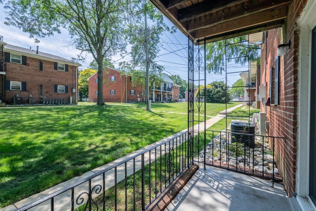 the view of the yard from the balcony of a house