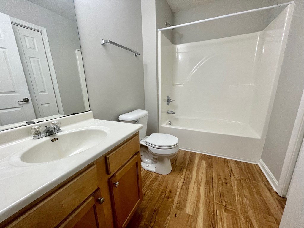 an empty bathroom with a sink toilet and shower