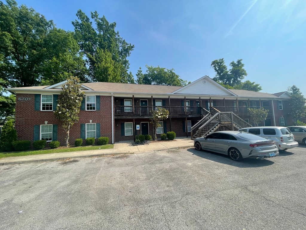 a large brick building with cars parked in front of it