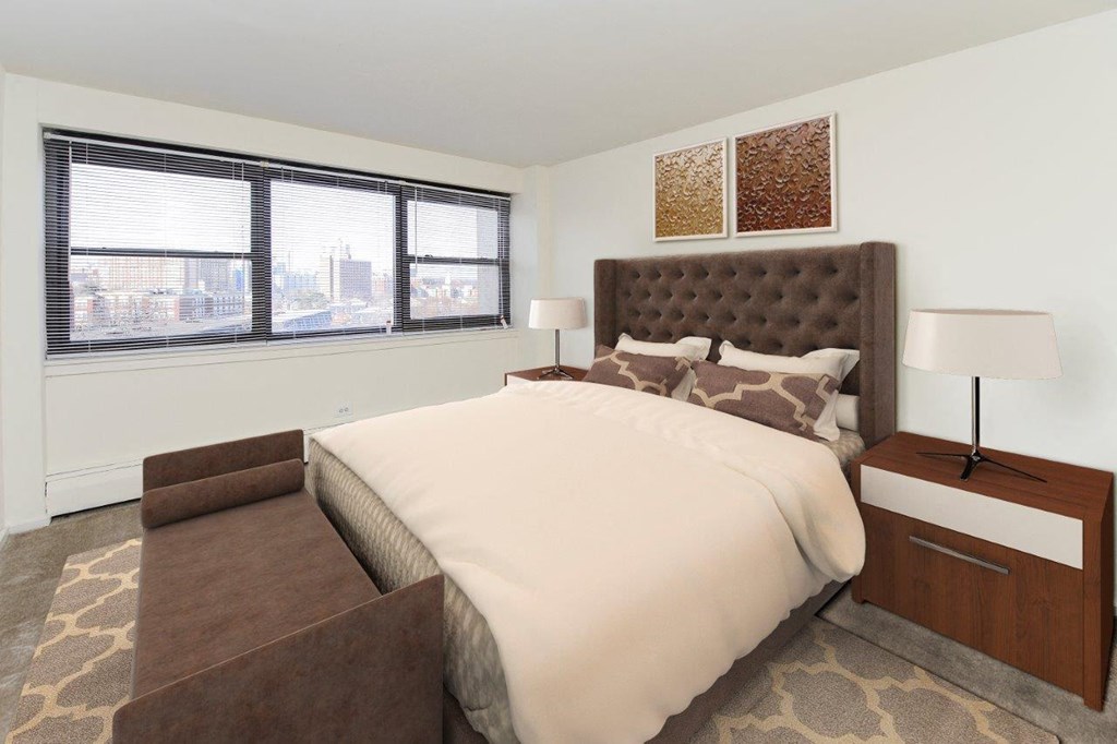 a bedroom with a large bed and a large window