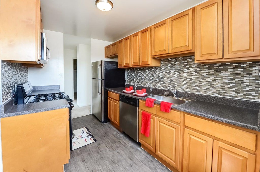 a kitchen with wooden cabinets and stainless steel appliances