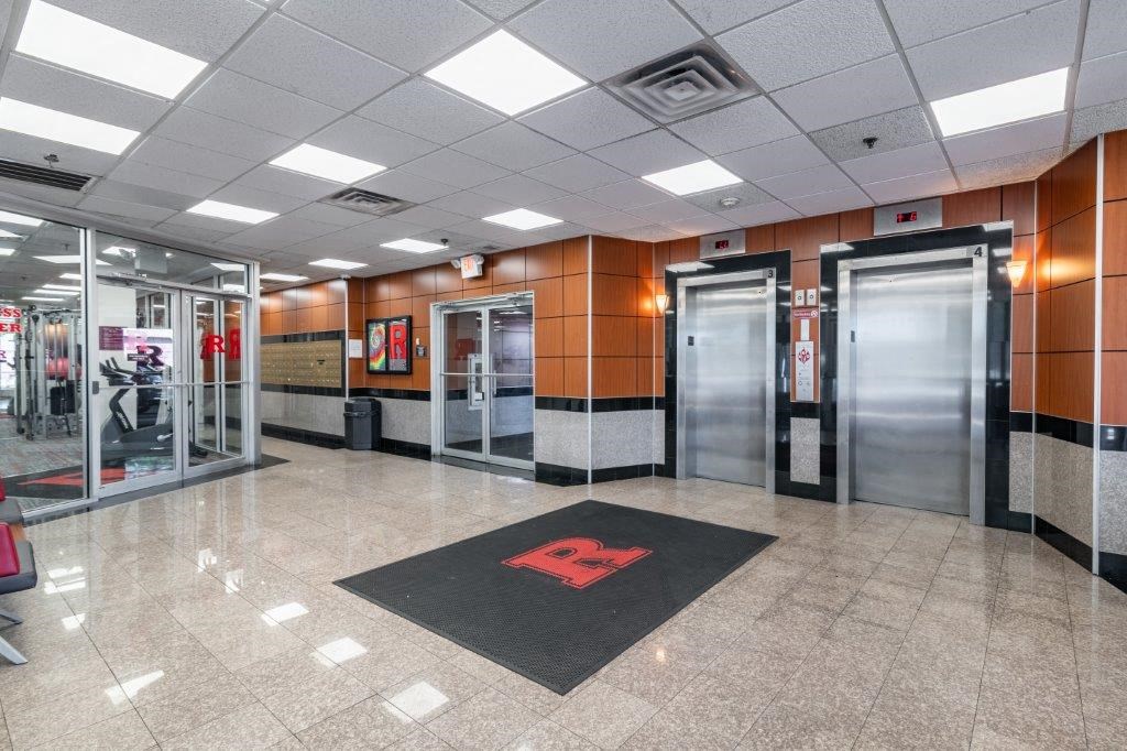 a lobby with elevators and doors in a building