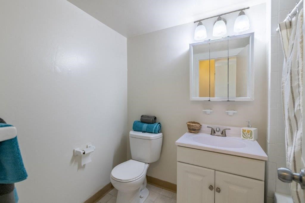 a bathroom with a sink toilet and a mirror