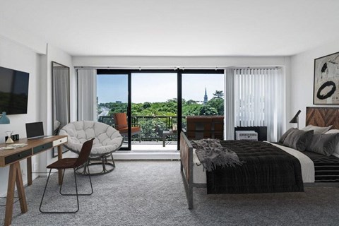 a bedroom with a bed and a desk and a window