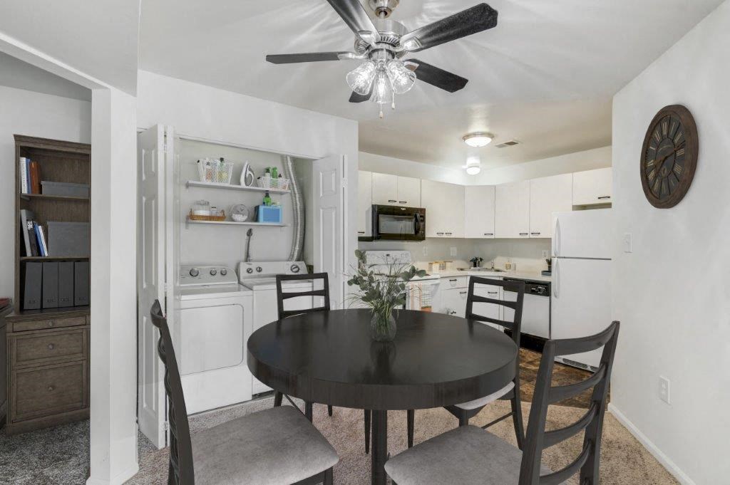 a kitchen and dining room with a table and a ceiling fan