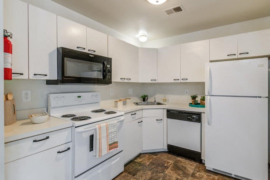 a kitchen with white appliances and white cabinets