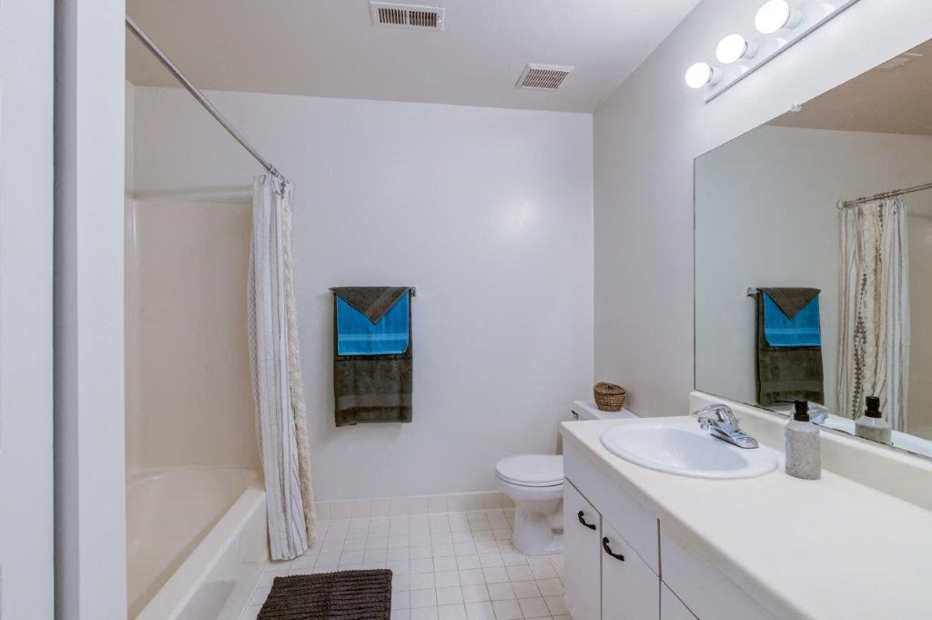 a bathroom with a sink toilet and a shower
