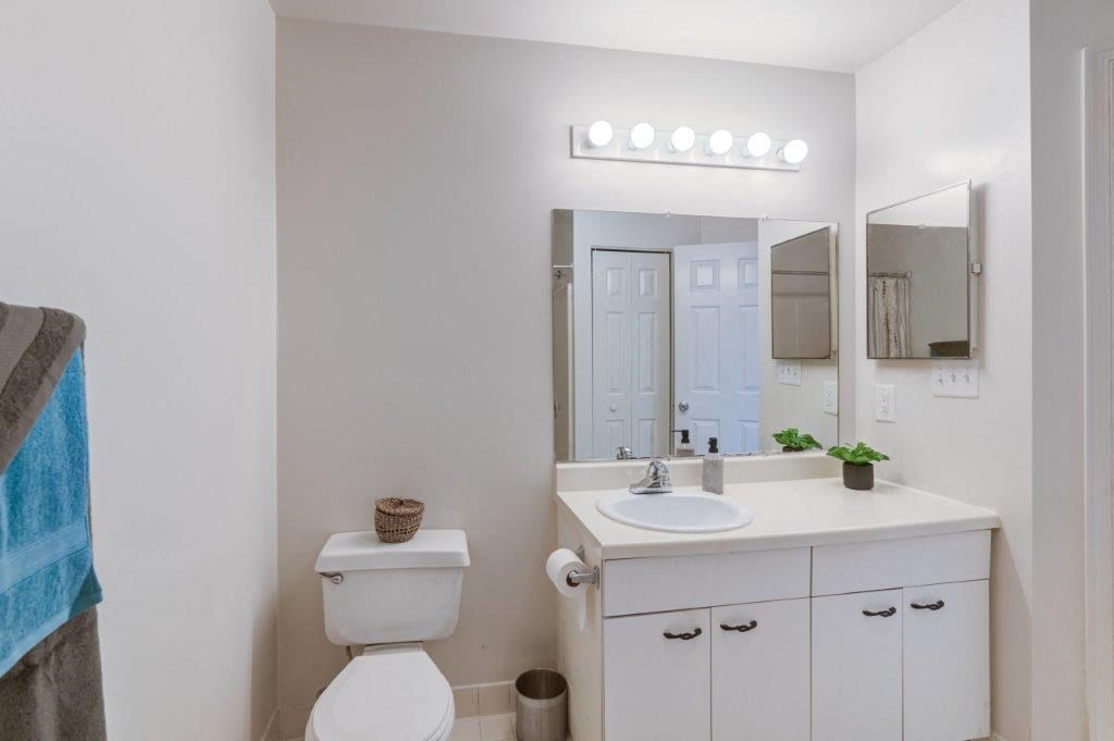 a bathroom with a sink toilet and a mirror